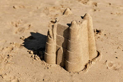 Close-up of carving on sand at beach