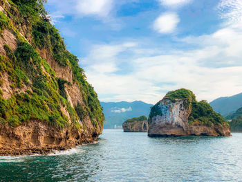 Scenic view of rocks in sea against sky