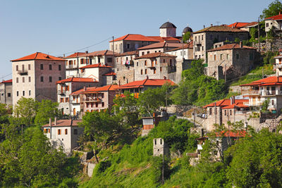 Buildings in city against clear sky