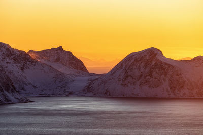 Scenic view of mountains against orange sky