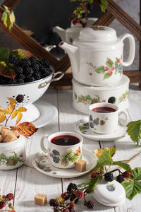 Fruit tea with ripe blackberries, vintage still life with beautiful retro set