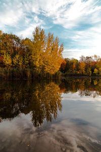 Reflection of trees in lake against sky during autumn