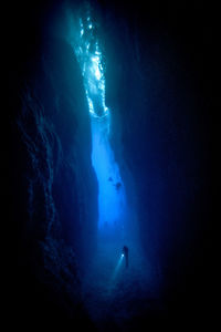 Man swimming in sea at night