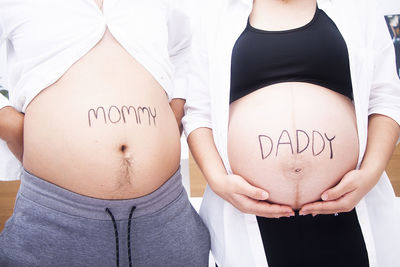 Midsection of woman standing with text