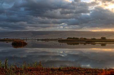 Scenic view of lake against sky during sunset