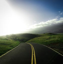 Road passing through landscape against sky