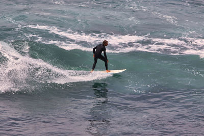 Full length of man surfing in sea