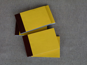 High angle view of yellow paper on table