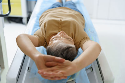 High angle view of boy sleeping on bed at home