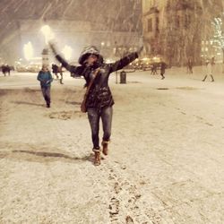 Full length of people walking on snow covered beach