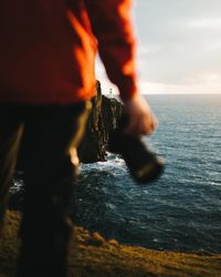 Blurred motion of man standing in sea against sky