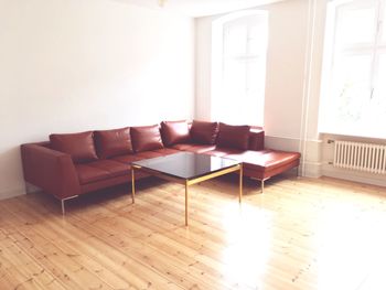 Empty sofa on hardwood floor at home