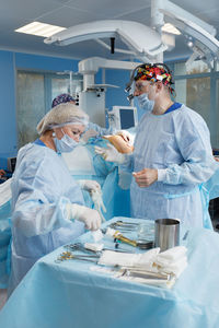 Female dentist examining patient in laboratory