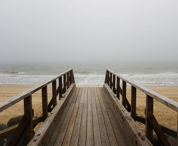 Pier over sea against clear sky