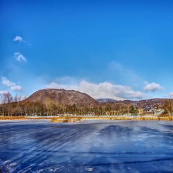 Scenic view of lake against blue sky