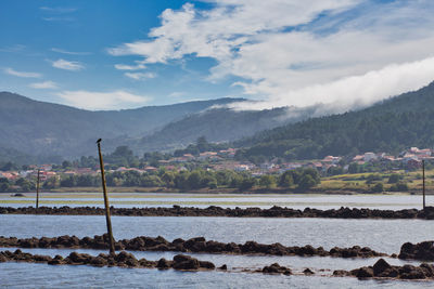 A sea of white clouds going down the mountains to village of noia in galicia, spain and reaching sea