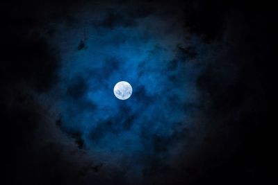 Scenic view of moon against blue sky at night