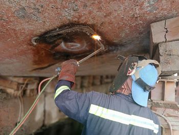 Welder on duty cutting vessel bottom plate