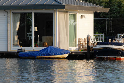 Boats moored in canal by building