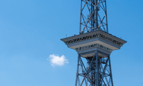 Low angle view of communications tower against blue sky