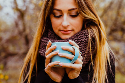 Portrait of beautiful woman using smart phone outdoors