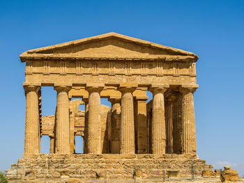 Low angle view of historical building against clear blue sky