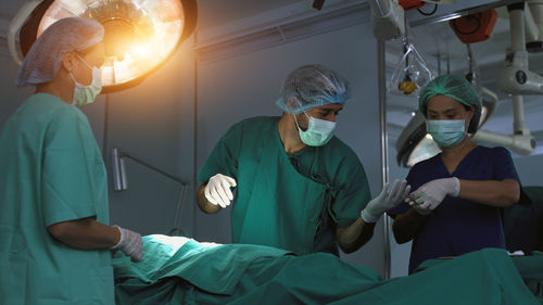Portrait of male dentist examining patient at clinic