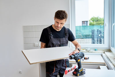 Side view of man working at home