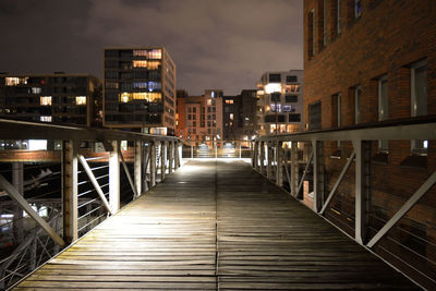 Footbridge by building in city