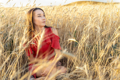 Beautiful young woman in wheat field.