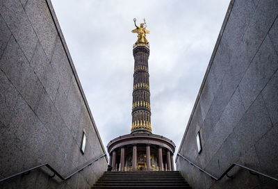 Low angle view of statue of historic building against sky