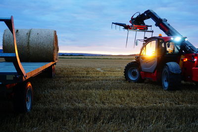 Tractor on agricultural field against sky