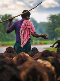 Woman holding umbrella standing outdoors