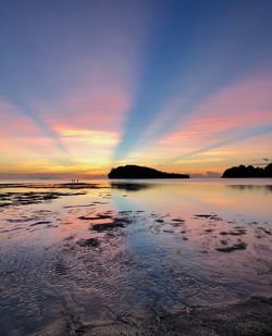 Scenic view of sea against romantic sky at sunset