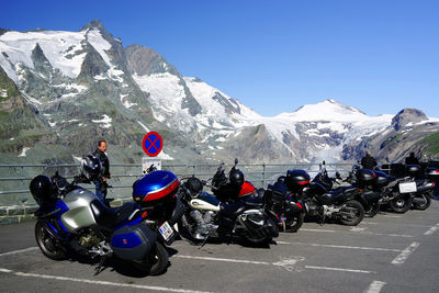 People on snowcapped mountains against sky