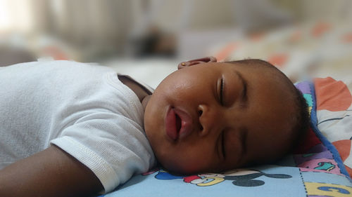 Close-up of boy sleeping on bed