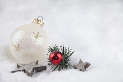 Close-up of christmas decorations on snow