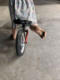 Low section of person riding bicycle on street