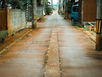Empty road along buildings
