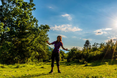 Full length of man standing on field against sky