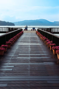 View of boardwalk in water against sky