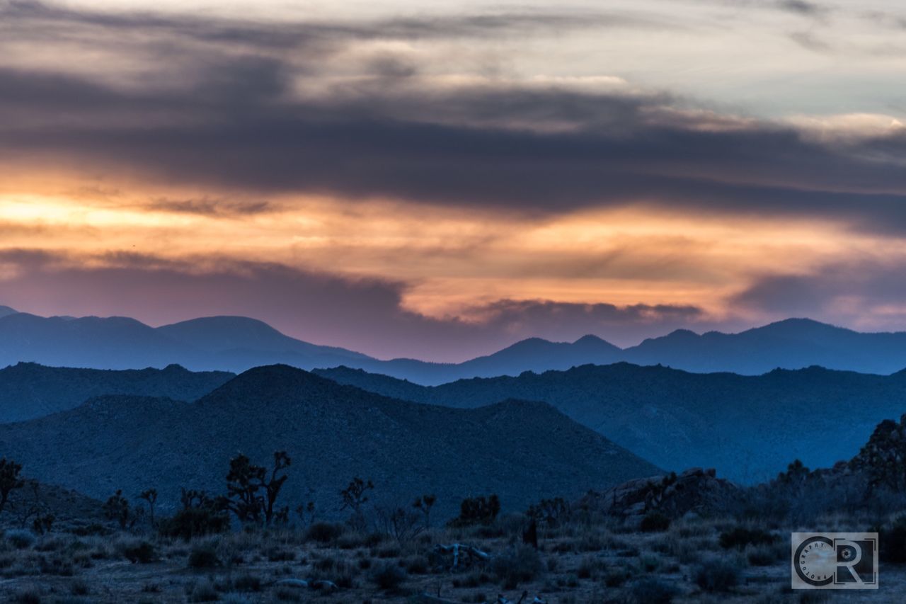 SCENIC VIEW OF MOUNTAINS AGAINST SUNSET SKY