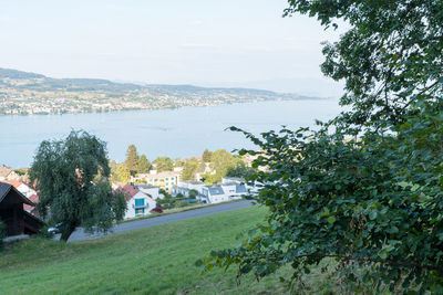 Scenic view of sea by city against sky