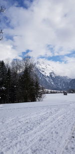 Snow covered field against sky