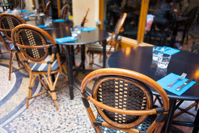 High angle view of empty chairs and tables at restaurant