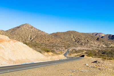 Scenic view of mountains against clear blue sky