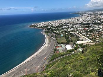 High angle view of sea and buildings against sky