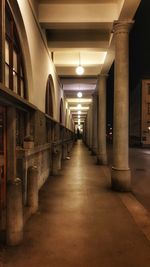 Empty corridor in illuminated building