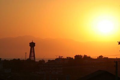 Silhouette of buildings against sky during sunset