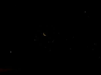 Low angle view of moon against sky at night